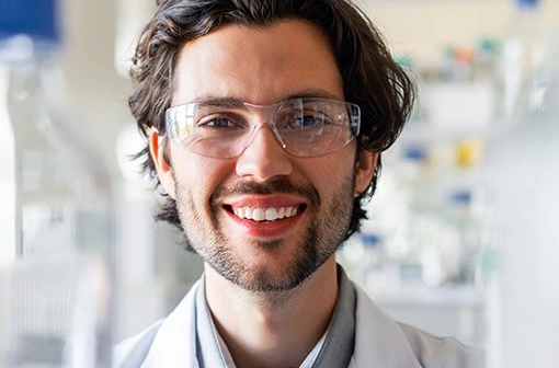 Happy male scientist wearing protective eyewear