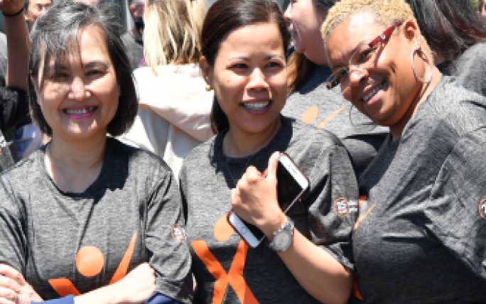 Three female Exelixis employees smiling at volunteer event