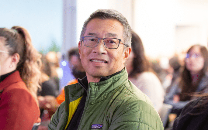 Male employee smiling at a community event