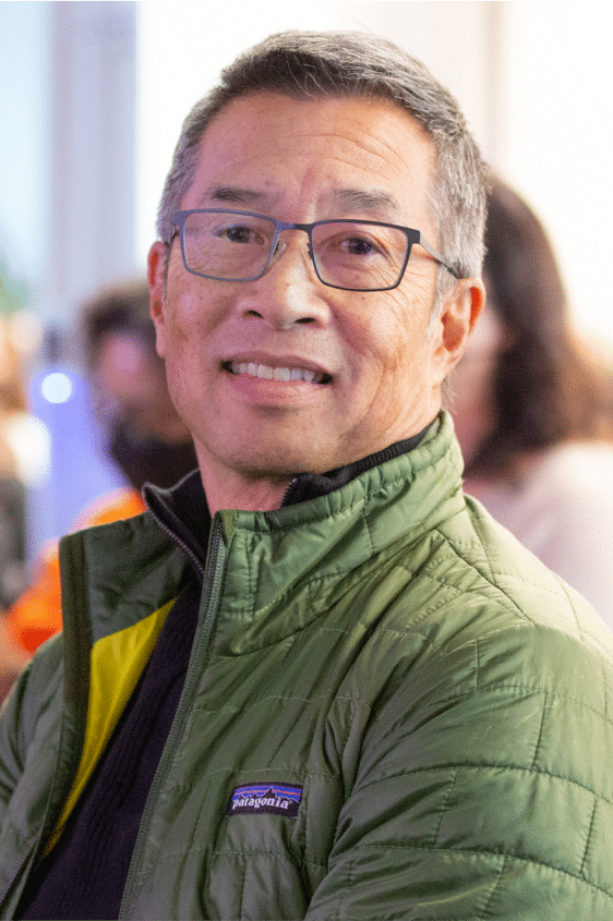 Male employee smiling at a community event