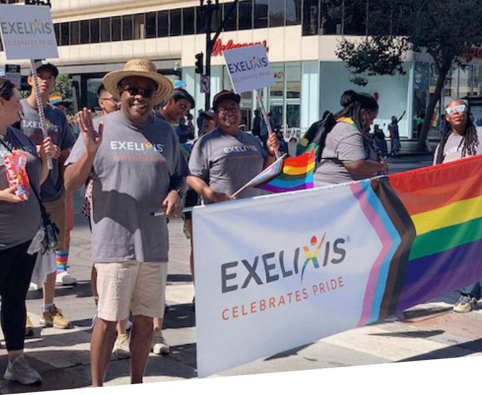 Employees holding pride celebration flag and walking in parade