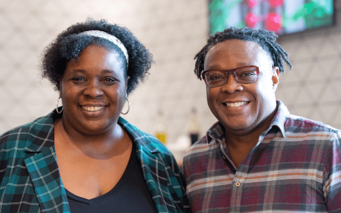 Two employees smiling for camera