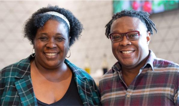 Two employees smiling for camera