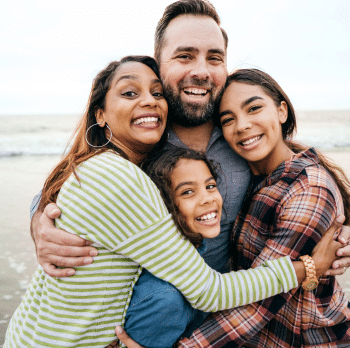 Family of four hugging