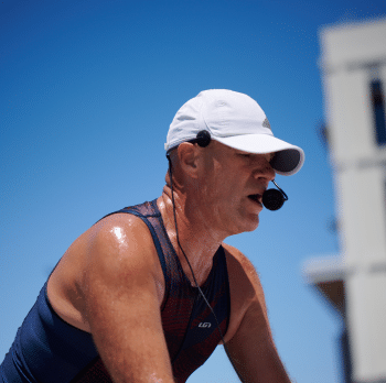 Male spin instructor leading class