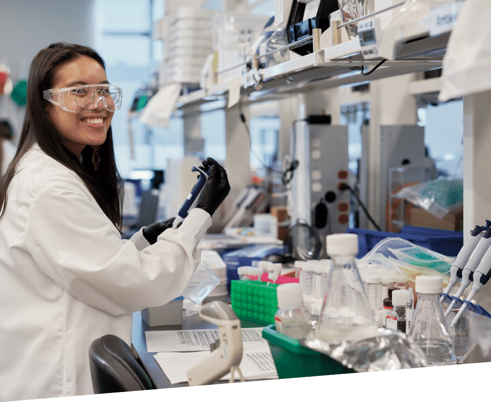 Female scientist smiling at lab station