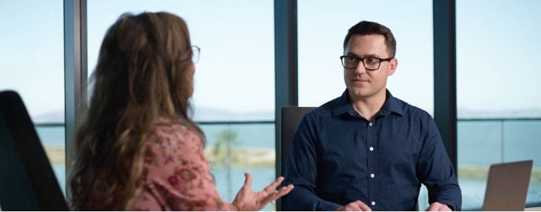 Two employees talking at a table