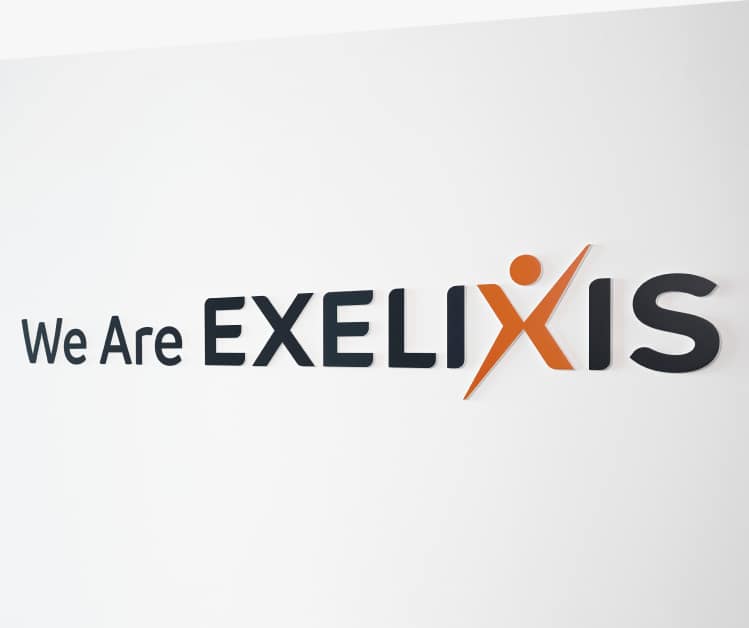 “We are Exelixis” sign on white wall